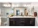 Contemporary bathroom with a double vanity, large mirror, stylish lighting, and glass shower at 5 Harrison St, Denver, CO 80206