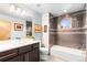 Modern bathroom boasting stylish tiles, vanity, and a shower/tub combo with natural light at 5 Harrison St, Denver, CO 80206