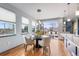 Bright dining area with modern lighting, hardwood floors, and views of the outside patio; perfect for Gathering meals and entertaining at 5 Harrison St, Denver, CO 80206