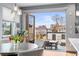 Bright dining area featuring glass doors opening to outdoor patio with neighborhood views at 5 Harrison St, Denver, CO 80206