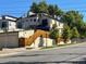 Modern home featuring clean lines, multiple levels, and a rooftop deck with mature shade trees around the property at 5 Harrison St, Denver, CO 80206