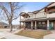 Charming two-story home featuring a covered porch with stone columns and a manicured front yard at 5 Harrison St, Denver, CO 80206