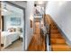 Hallway with staircase, hardwood floors, and a glimpse into a well-lit bedroom at 5 Harrison St, Denver, CO 80206