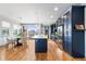 Modern kitchen featuring stainless steel appliances, quartz countertops, a large island and bright light at 5 Harrison St, Denver, CO 80206