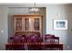 The dining area features a wooden table, chairs, and a decorative hutch with glass doors at 6290 Virgil St, Arvada, CO 80403