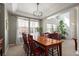 Formal dining room with a large table, six chairs, and natural light from the windows at 6290 Virgil St, Arvada, CO 80403