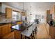 Bright kitchen with stainless steel appliances, island with bar seating, and adjacent dining area at 6290 Virgil St, Arvada, CO 80403