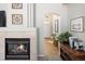 Living room featuring a fireplace with white tile surround, and an entry hall with hardwood floors at 6290 Virgil St, Arvada, CO 80403