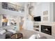 Cozy living room with a fireplace, large windows, and an open view into kitchen and dining at 6290 Virgil St, Arvada, CO 80403