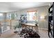 Open loft area used as a home office with a desk, bookshelves and a cowhide rug at 6290 Virgil St, Arvada, CO 80403