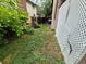 Side yard featuring lush greenery, a partial fence, and convenient side yard access at 3246 S Nucla St, Aurora, CO 80013