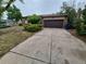 View of the house with a driveway and a garage and some landscaping at 3246 S Nucla St, Aurora, CO 80013