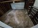 Spacious unfinished garage with overhead door and open wall studs at 3246 S Nucla St, Aurora, CO 80013