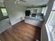 Eat-in kitchen with wood floors, breakfast bar, and a view into the bright living space at 3246 S Nucla St, Aurora, CO 80013