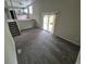 Open-concept living space with modern carpeting, sliding glass door, and staircase leading to an additional room at 3246 S Nucla St, Aurora, CO 80013
