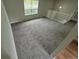 A cozy living space featuring neutral-toned carpeting, a bright window, and a partial view of the upper level at 3246 S Nucla St, Aurora, CO 80013
