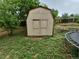 Backyard storage shed flanked by mature trees and next to a trampoline at 3246 S Nucla St, Aurora, CO 80013