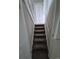 Staircase features neutral carpeted steps, and white railings for easy transition at 3246 S Nucla St, Aurora, CO 80013