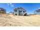 View of the home with an unfinished backyard space and wooden fence, perfect for creating your dream outdoor retreat at 39628 Yorktown Ter, Elizabeth, CO 80107