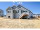 Exterior view of a home with a back deck and unfinished yard, ready for landscaping and outdoor enjoyment at 39628 Yorktown Ter, Elizabeth, CO 80107