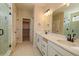 Contemporary bathroom boasts double sinks, closet access and a glass-enclosed shower, creating a spa-like atmosphere at 39628 Yorktown Ter, Elizabeth, CO 80107
