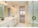 Stylish bathroom showcasing a double vanity, modern fixtures, and a glass-enclosed shower for a luxurious feel at 39628 Yorktown Ter, Elizabeth, CO 80107