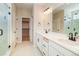 Well-lit bathroom featuring double sinks, a walk-in closet, and a modern glass shower, perfect for relaxation at 39628 Yorktown Ter, Elizabeth, CO 80107
