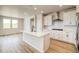 Modern kitchen featuring white cabinets, a center island, and stainless steel appliances at 39628 Yorktown Ter, Elizabeth, CO 80107