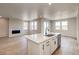 Open living area with a modern fireplace and plenty of natural light from large windows at 39628 Yorktown Ter, Elizabeth, CO 80107
