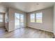 Spacious living area with wood floors, large windows, and sliding door to deck offering seamless indoor-outdoor living at 39628 Yorktown Ter, Elizabeth, CO 80107