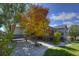Spacious backyard featuring a deck, mature trees, and manicured landscaping at 698 Larimer Creek Dr, Monument, CO 80132