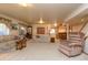 Finished basement with multiple seating areas, a wet bar, and carpet flooring at 698 Larimer Creek Dr, Monument, CO 80132