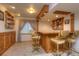 Finished basement bar featuring wood accents, shelving, and barstool seating at 698 Larimer Creek Dr, Monument, CO 80132