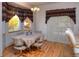 Dining room with wood floors, large windows, and curtains, complemented by a chandelier at 698 Larimer Creek Dr, Monument, CO 80132