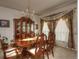 Formal dining room with elegant furnishings, window treatments and sophisticated chandelier at 698 Larimer Creek Dr, Monument, CO 80132