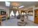 Bright living room featuring a fireplace, skylights and plush seating at 698 Larimer Creek Dr, Monument, CO 80132