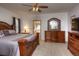Bedroom with carpet, detailed wood furniture, ceiling fan, and access to an ensuite bathroom at 698 Larimer Creek Dr, Monument, CO 80132