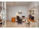 Bright home office featuring a built-in desk, cabinets, and a large window at 698 Larimer Creek Dr, Monument, CO 80132