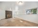 Cozy basement featuring a brick fireplace and well lit windows at 1533 S Jamaica St, Aurora, CO 80012
