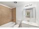 Clean bathroom featuring a tub with tile surround and vanity with a mirrored cabinet at 1533 S Jamaica St, Aurora, CO 80012