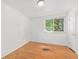Sunlit bedroom featuring hardwood floors and a large window at 1533 S Jamaica St, Aurora, CO 80012