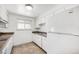 Well-lit kitchen featuring tile floors, appliances, and bright cabinets at 1533 S Jamaica St, Aurora, CO 80012
