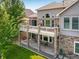 Aerial view of the backyard with a deck, patio, and stone columns at 13943 W 87Th Ln, Arvada, CO 80005