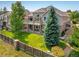 Aerial view of a backyard with a deck, patio, and well-maintained lawn at 13943 W 87Th Ln, Arvada, CO 80005