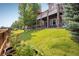 Beautiful backyard featuring a stone patio, outdoor deck, and garden at 13943 W 87Th Ln, Arvada, CO 80005
