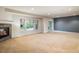 Spacious basement area with a fireplace and multiple windows for natural light at 13943 W 87Th Ln, Arvada, CO 80005