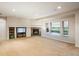 Entertainment space with fireplace and large windows at 13943 W 87Th Ln, Arvada, CO 80005