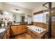 Luxurious bathroom with a soaking tub and glass-enclosed shower at 13943 W 87Th Ln, Arvada, CO 80005