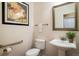 Powder room with a pedestal sink and decorative mirror at 13943 W 87Th Ln, Arvada, CO 80005