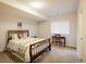 Bedroom featuring a decorative bed frame, natural light, and a desk, creating a serene atmosphere at 13943 W 87Th Ln, Arvada, CO 80005